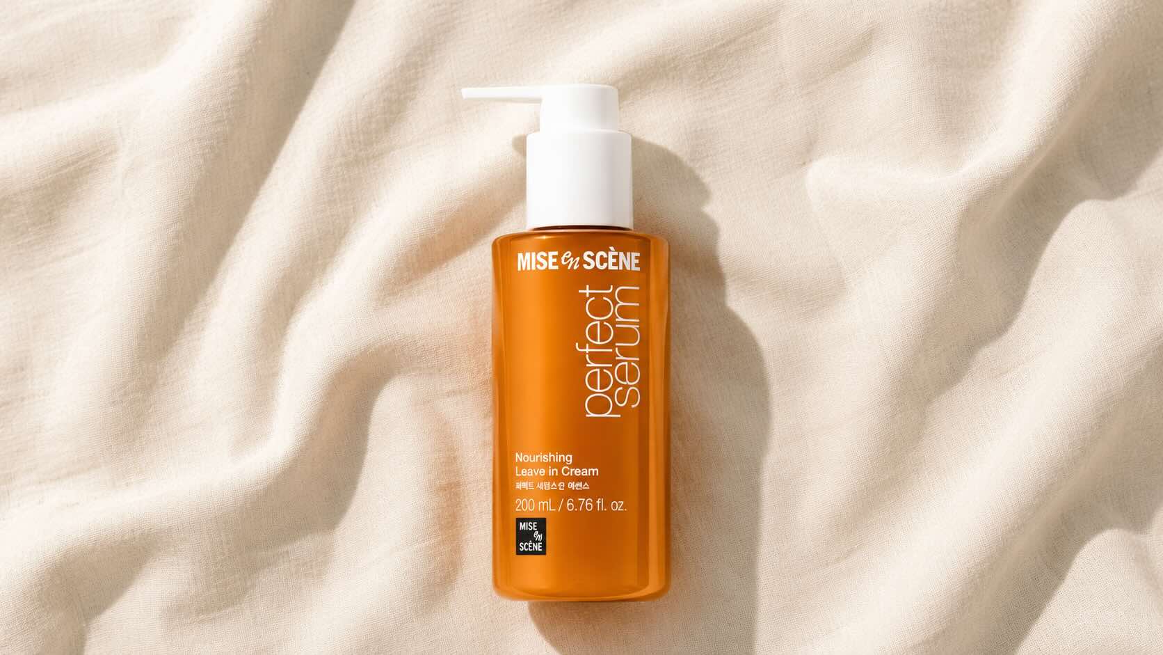 Mise en Scène Perfect Serum Original gold pump bottle on neutral cream background with minimalist styling