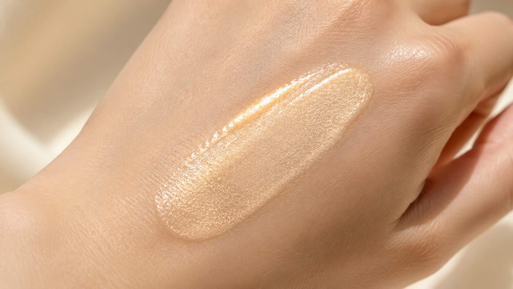 e.l.f. Halo Glow Liquid Filter pearlescent formula on the back of a hand showing luminous texture