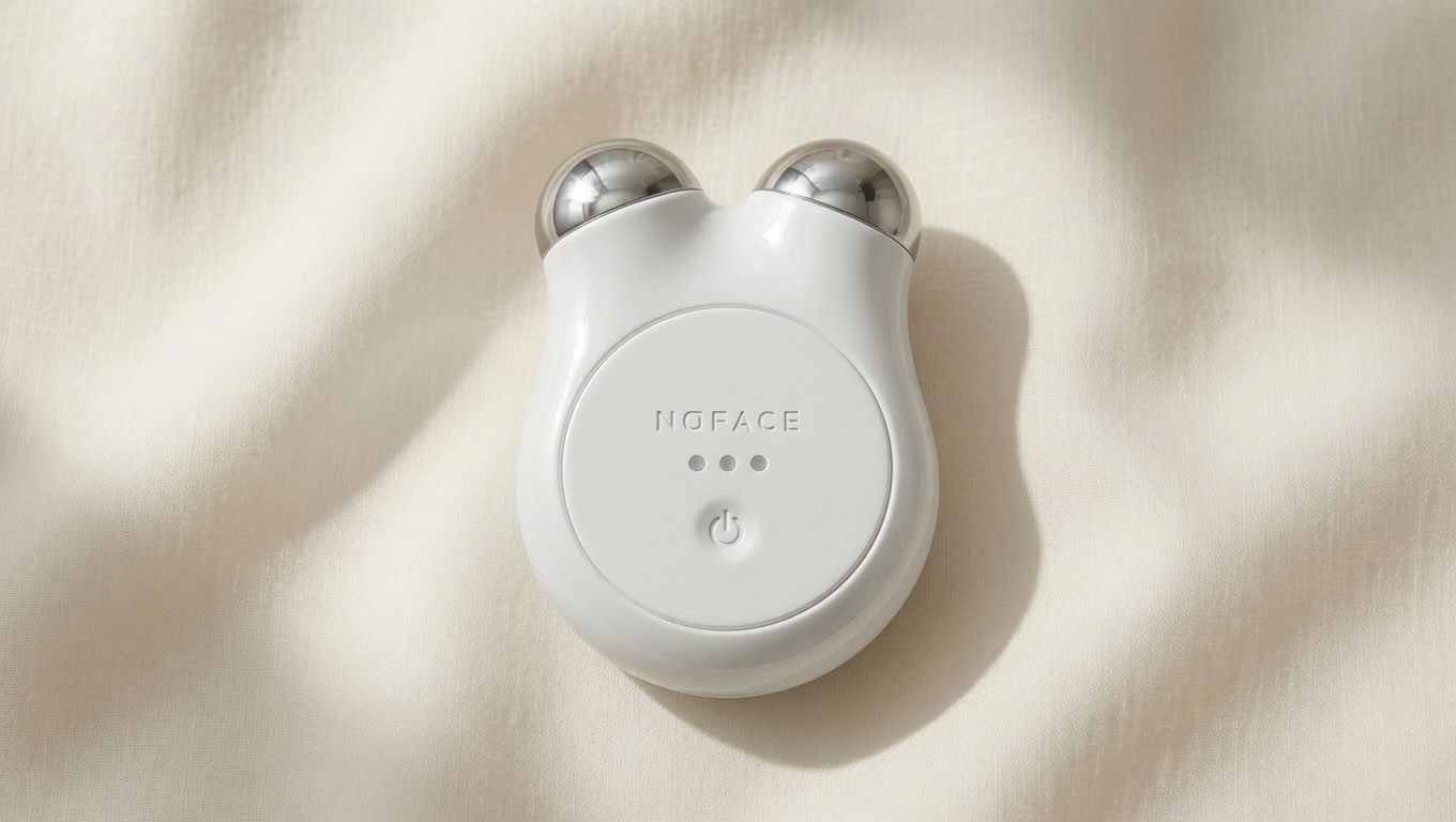 NuFACE Mini Facial Toning Device rose gold device on neutral cream background