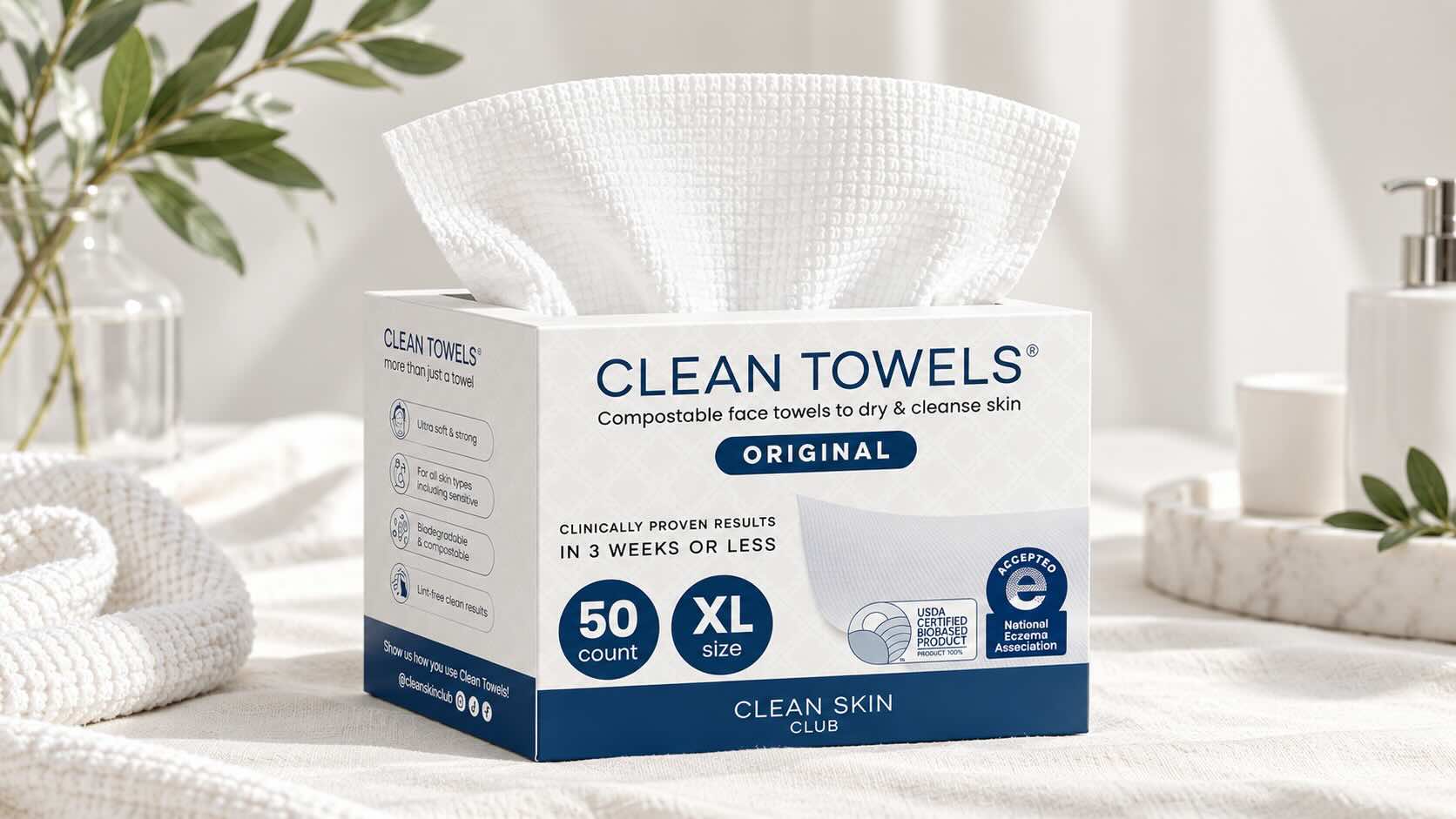 Clean Skin Club Clean Towels XL white disposable face towels on neutral cream background with minimal styling