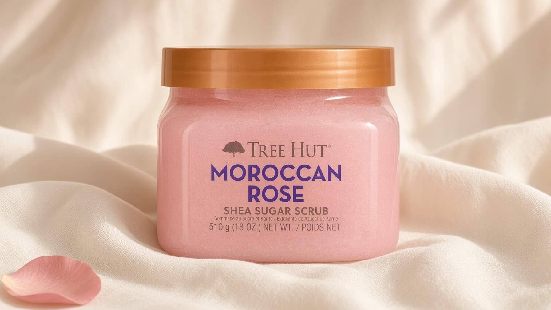 Tree Hut Shea Sugar Body Scrub Moroccan Rose pink jar on neutral cream background with dried rose petal styling